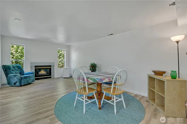 a view of a dining room with furniture and a fireplace