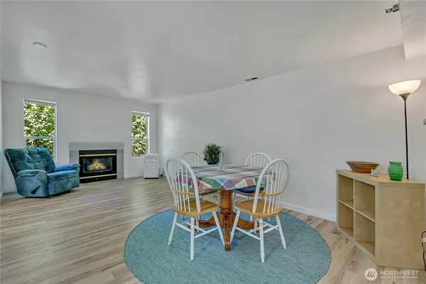 a view of a dining room with furniture and a fireplace