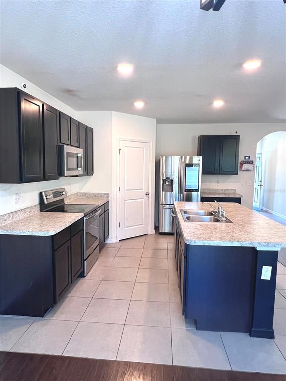 321 Blue Point Drive Ruskin, FL 33570 - Photo 6 of 18 a kitchen with stainless steel appliances kitchen island granite countertop a sink and cabinets
