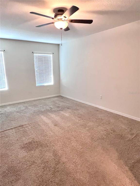 321 Blue Point Drive Ruskin, FL 33570 - Photo 10 of 18 an empty room with windows and fan