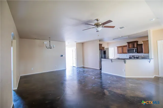 a view of a kitchen with wooden floor and a kitchen space