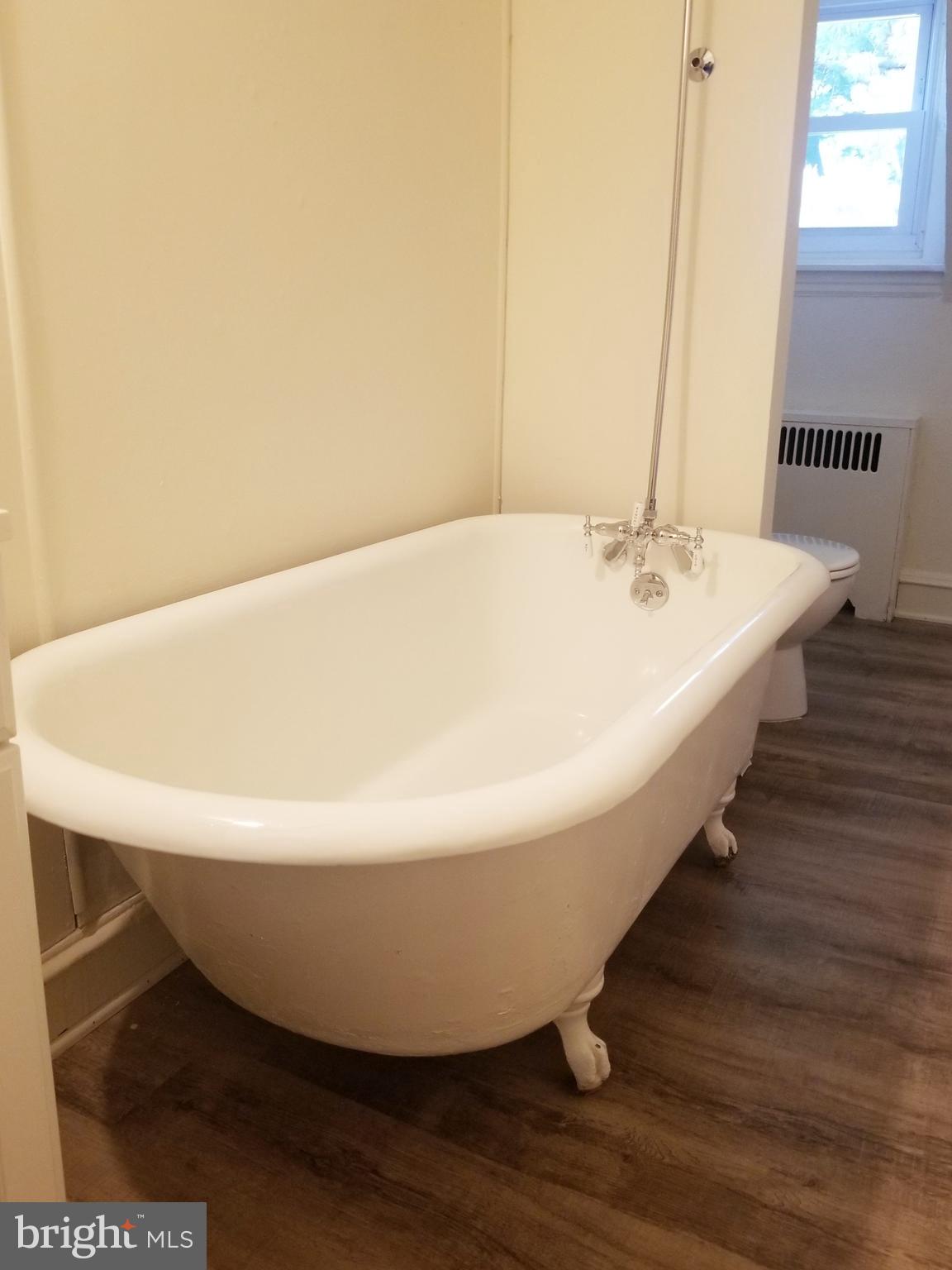 a white bath tub sitting in a bathroom