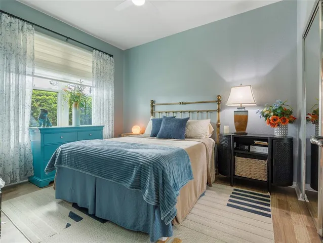 a bedroom with a bed and wooden floor