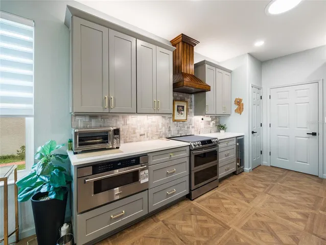 a kitchen with stainless steel appliances a stove a sink and a refrigerator