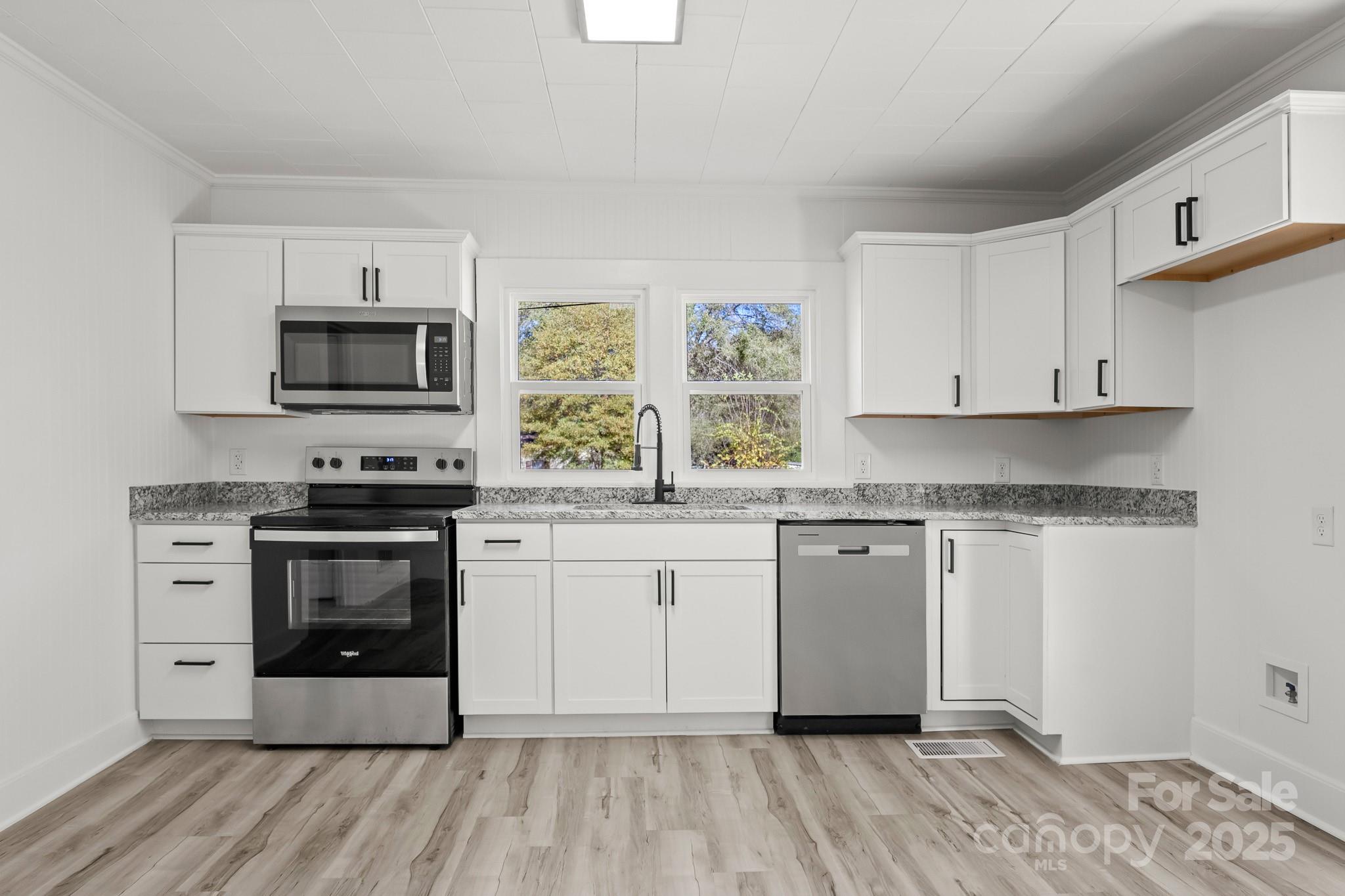 418 Charlotte Street York, SC 29745 - Photo 11 of 37 a kitchen with stainless steel appliances granite countertop a stove a sink and a microwave