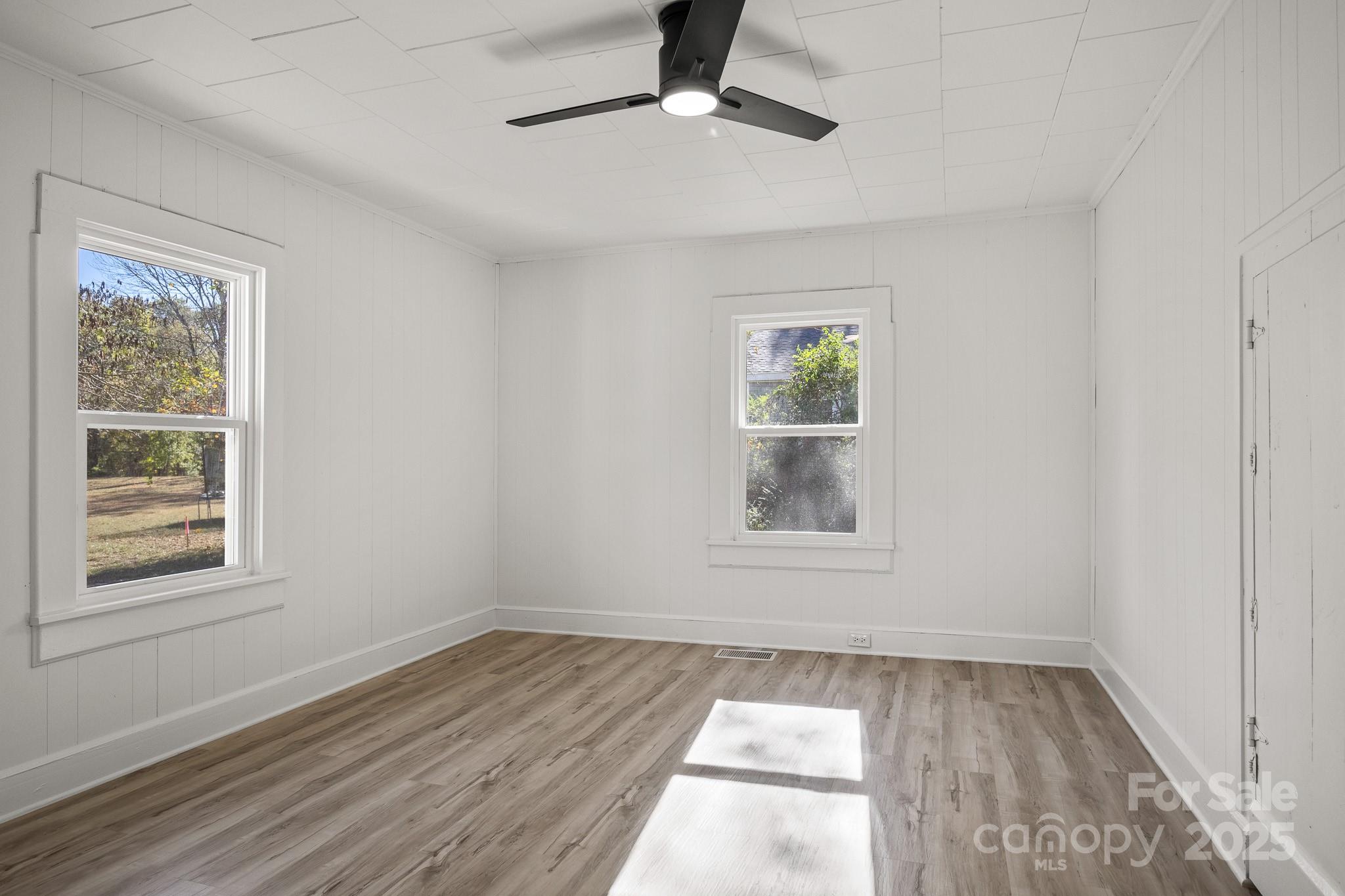 418 Charlotte Street York, SC 29745 - Photo 19 of 37 a view of empty room with wooden floor and fan