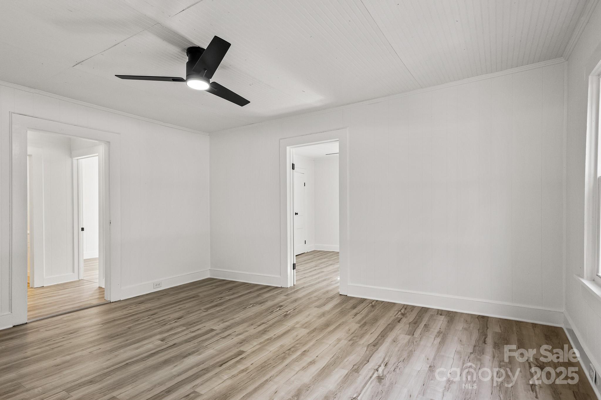 418 Charlotte Street York, SC 29745 - Photo 22 of 37 an empty room with wooden floor fan and windows