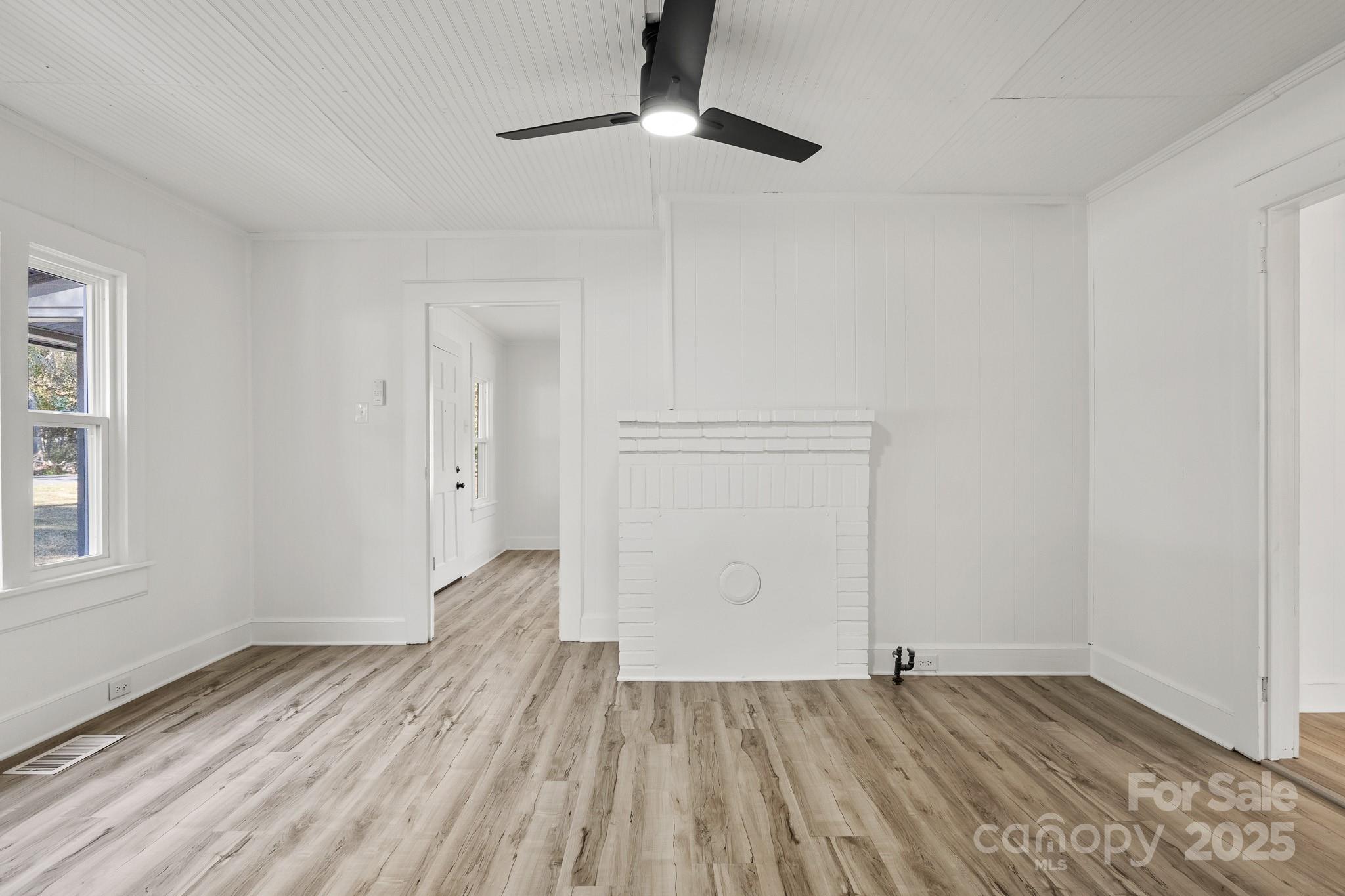 418 Charlotte Street York, SC 29745 - Photo 24 of 37 a view of empty room with wooden floor and fan