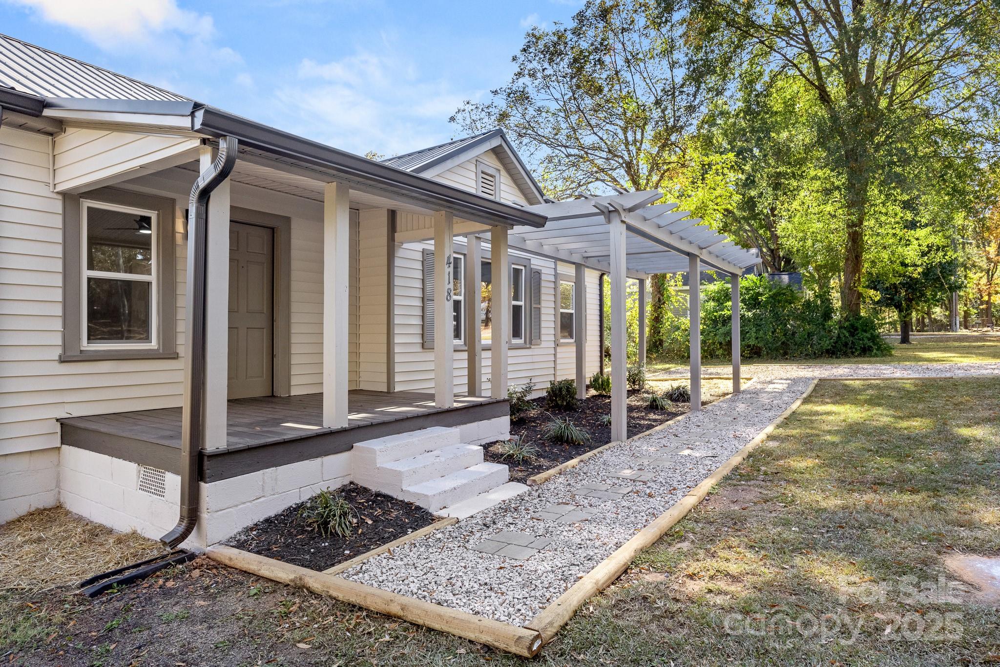 418 Charlotte Street York, SC 29745 - Photo 3 of 37 a front view of a house with garden
