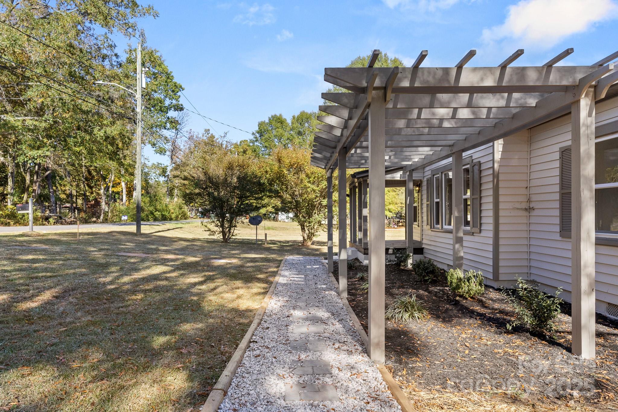 418 Charlotte Street York, SC 29745 - Photo 35 of 37 a view of a patio with table and chairs with wooden fence and plants