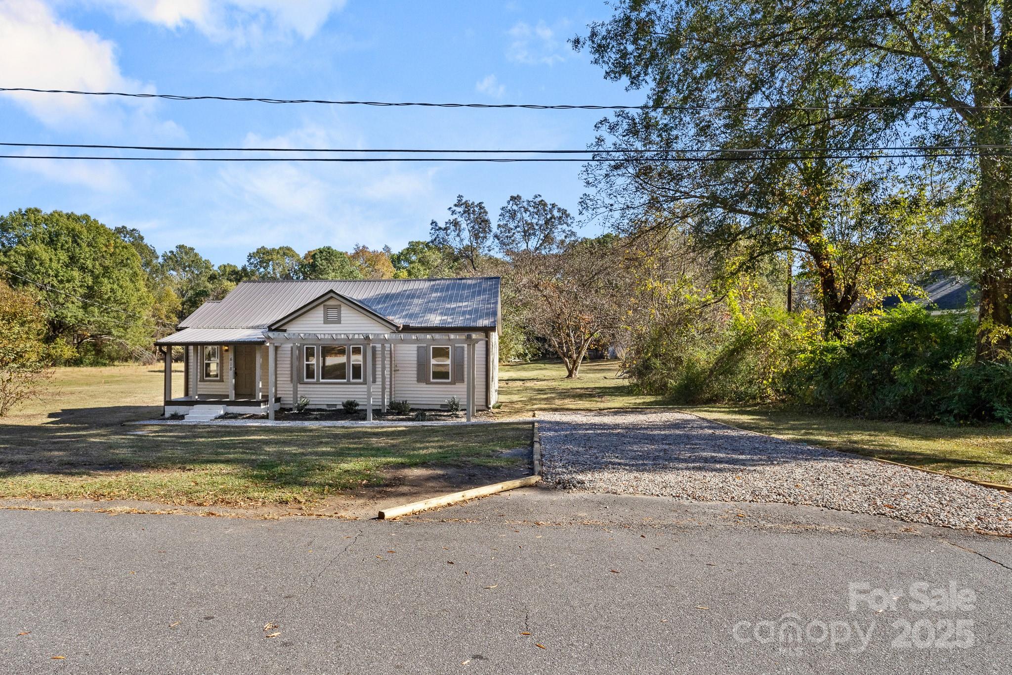418 Charlotte Street York, SC 29745 - Photo 36 of 37 a view of a house with a big yard and large tree