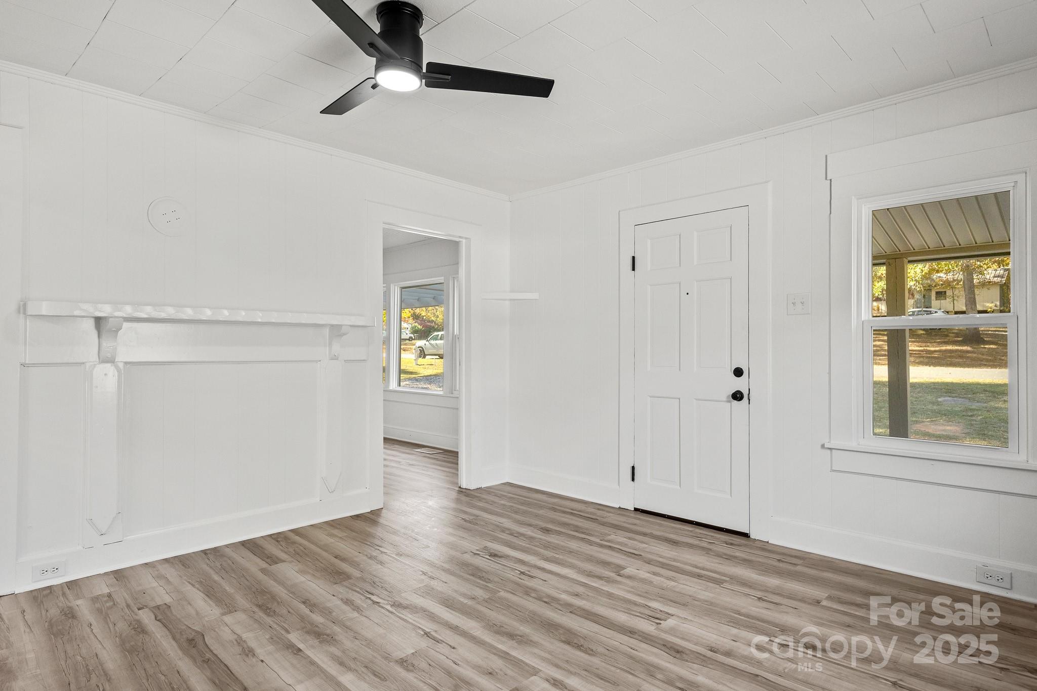 418 Charlotte Street York, SC 29745 - Photo 5 of 37 a view of an empty room with a window and wooden floor