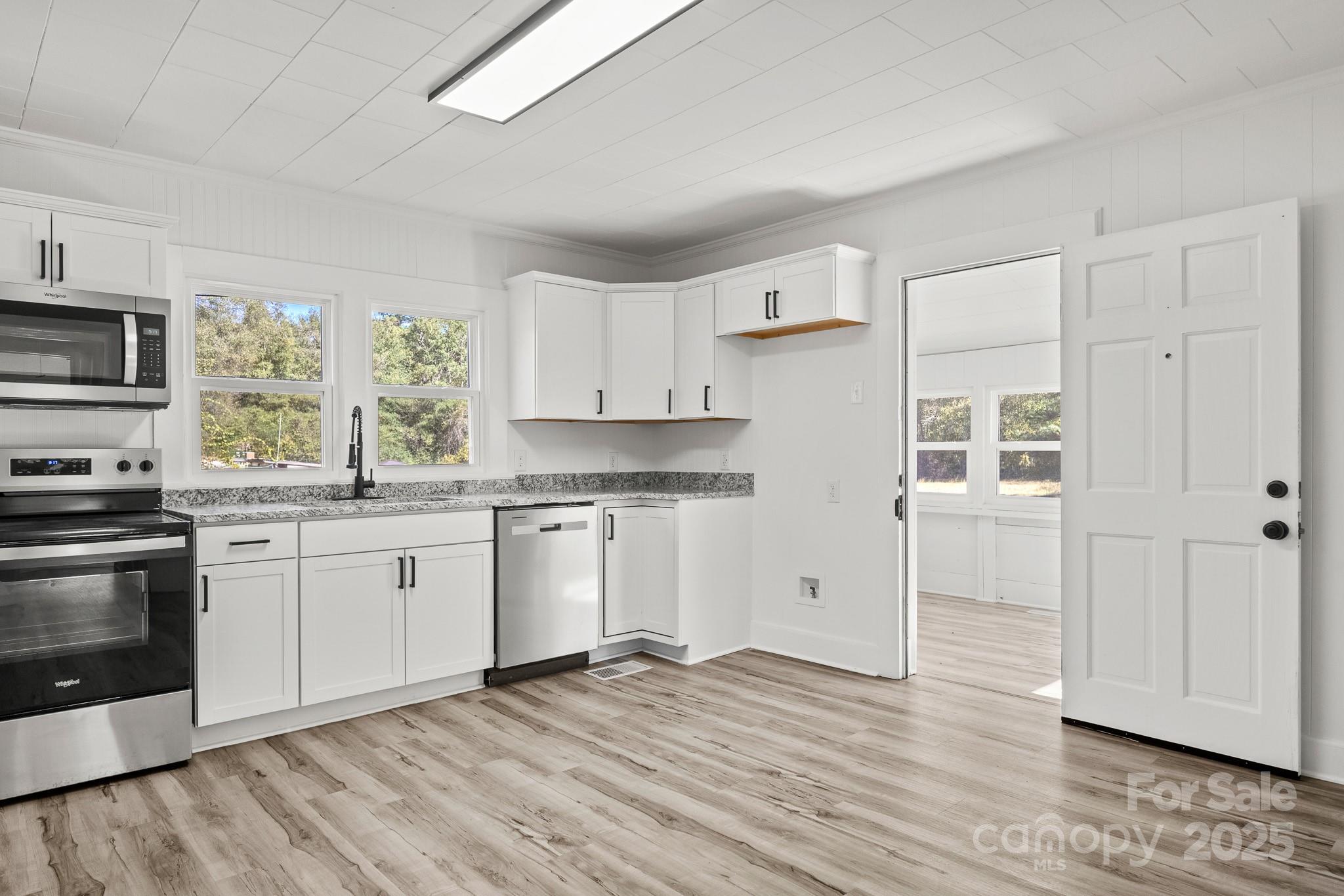 418 Charlotte Street York, SC 29745 - Photo 10 of 37 a kitchen with stainless steel appliances granite countertop a stove a sink and a refrigerator
