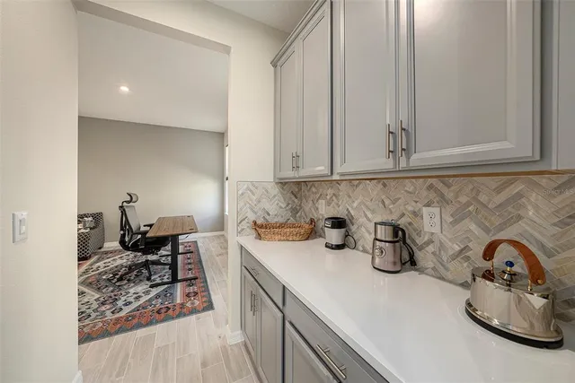 a kitchen with granite countertop a refrigerator stove and sink