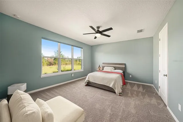 a bedroom with a large bed and a large window