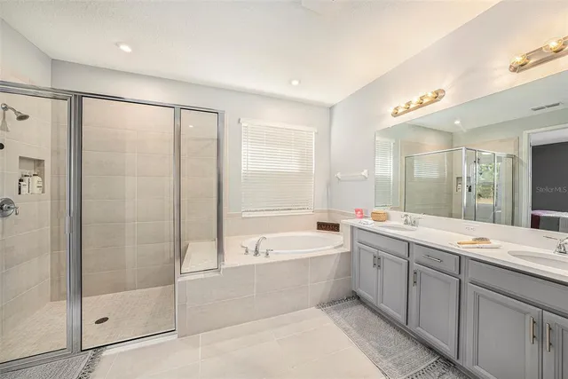 a bedroom with a bed and a ceiling fan