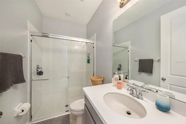 a bedroom with a bed and a chandelier fan