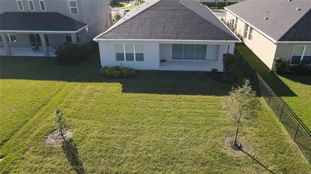 an aerial view of residential houses with outdoor space and swimming pool