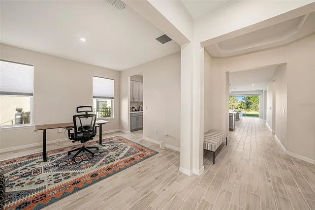 a living room with furniture rug and window
