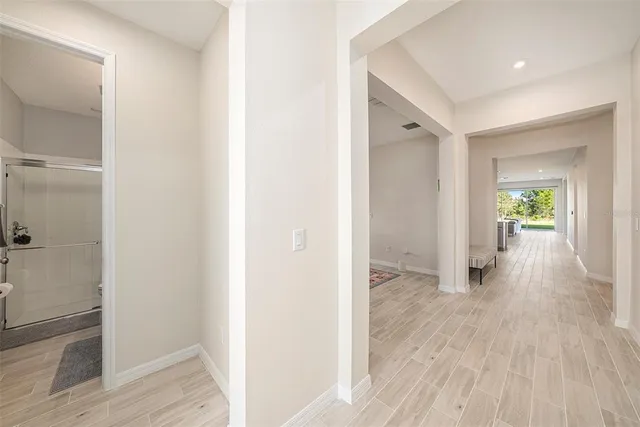 a kitchen with a refrigerator a sink dishwasher a stove and a refrigerator with wooden floor