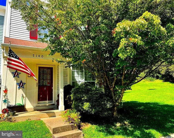 a view of a house with a tree in a yard