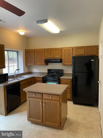 a kitchen with a sink and a refrigerator