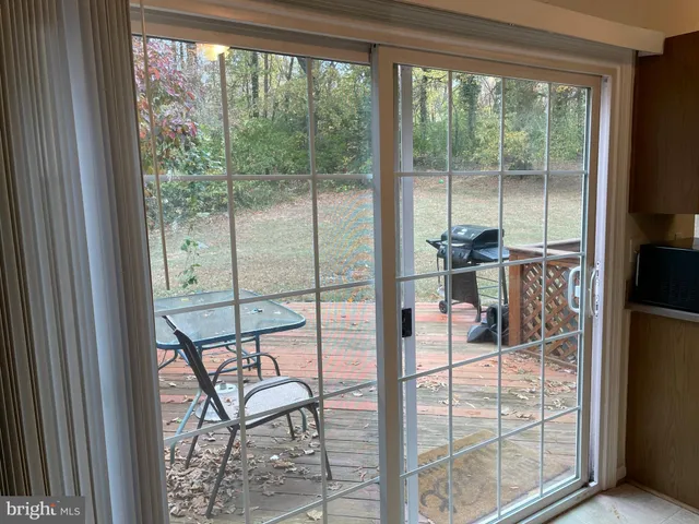 a room with a glass door and road view