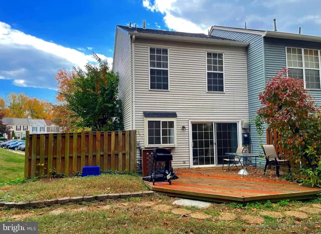 a backyard of a house with barbeque oven table and chairs