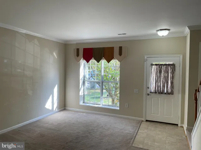 a view of a room with a fireplace and window