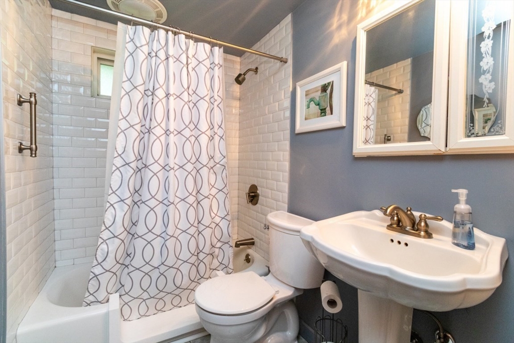 118 Bruce Road Walpole, MA 02081 - Photo 19 of 30 a bathroom with a sink a toilet and a mirror