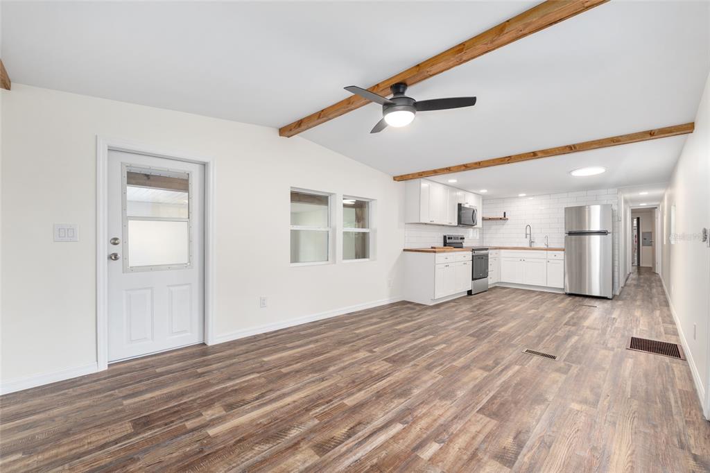 905 South Sunfish Avenue Inverness, FL 34450 - Photo 15 of 39 a view of a kitchen with wooden floor and a window
