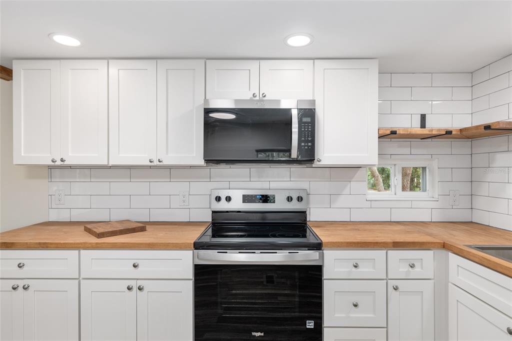 905 South Sunfish Avenue Inverness, FL 34450 - Photo 19 of 39 a kitchen with cabinets stainless steel appliances and a sink