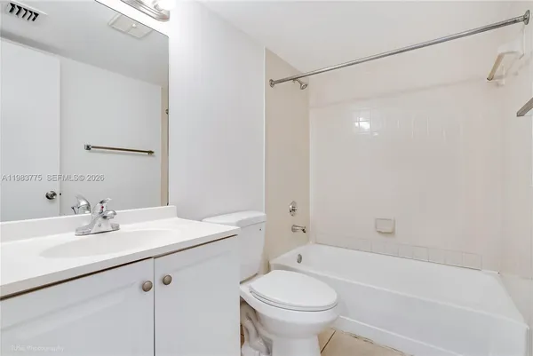 a bathroom with a sink mirror toilet and bathtub