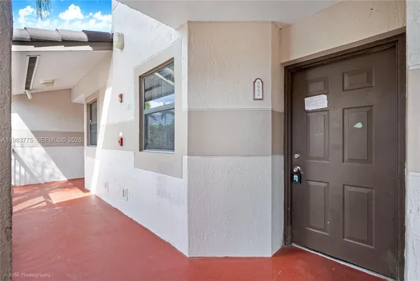 a view of a hallway with wooden floor and entryway
