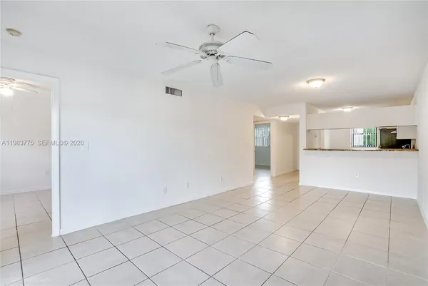 a view of a kitchen with a sink and a refrigerator