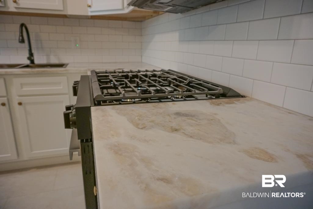 4667 Cottonwood Drive Mobile, AL 36608 - Photo 9 of 21 Kitchen featuring decorative backsplash, sink, and white cabinets