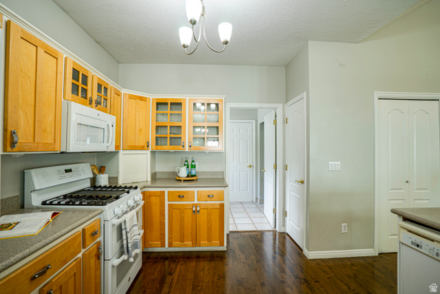 1433 Forge Way Draper, UT 84020 - Photo 9 of 29 Kitchen featuring wood-finish flooring, light wood cabinetry, white appliances, and light-toned countertops