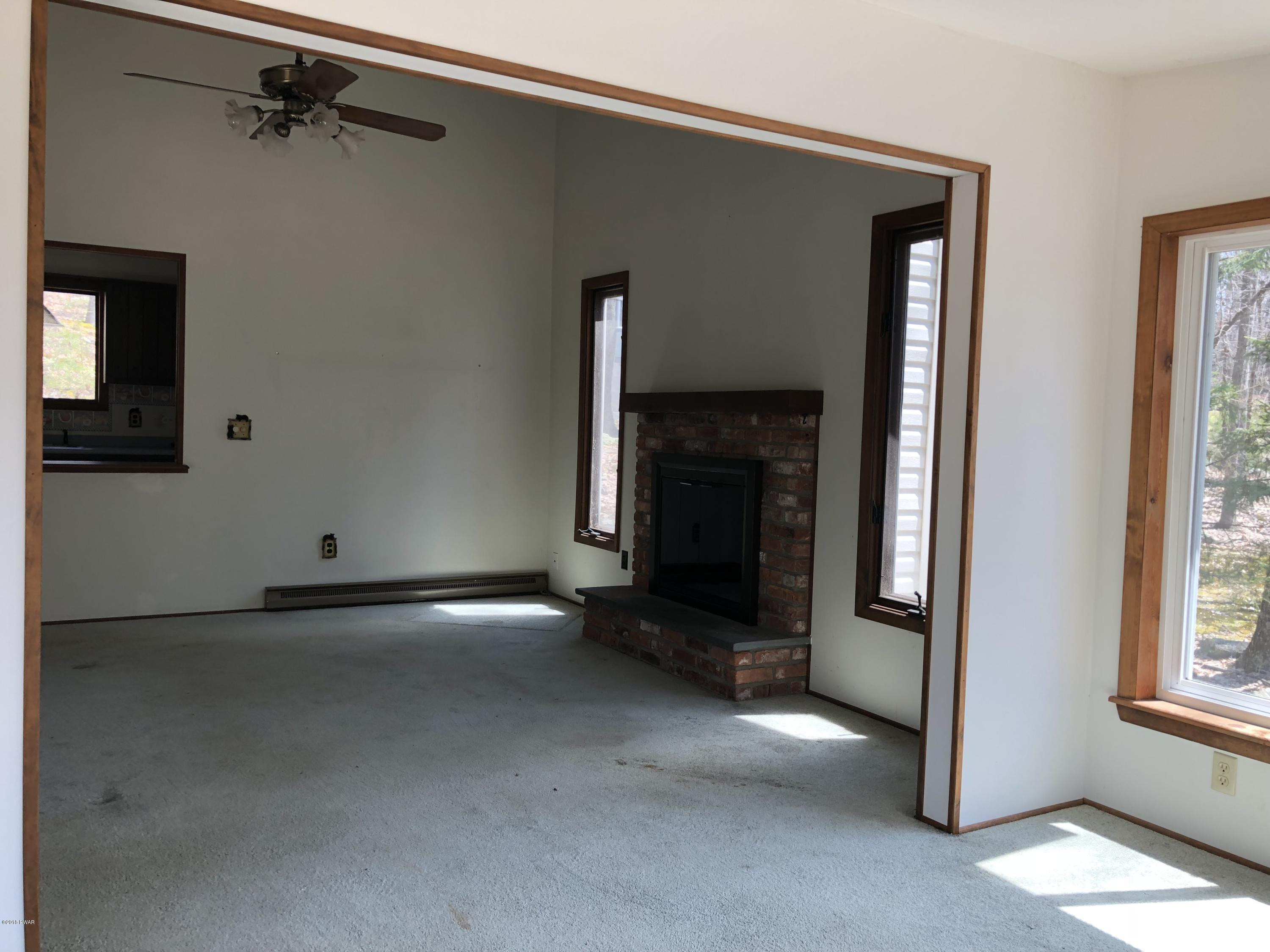 802 Conastoga Court Hawley, PA 18428 - Photo 11 of 37 12 fireplace from sunroom