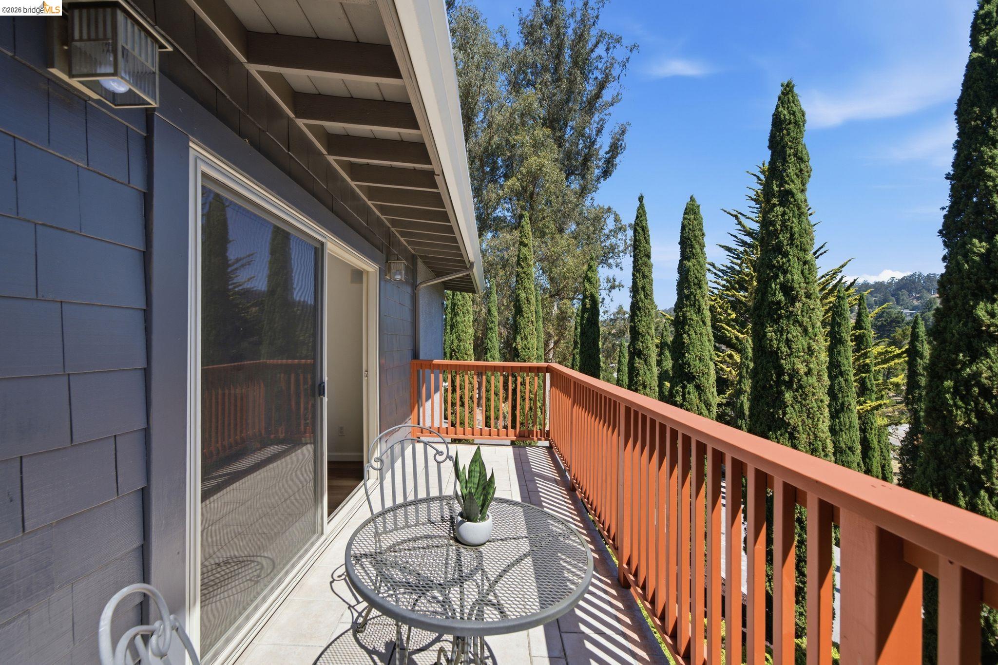 11133 Golf Links Road Oakland, CA 94605 - Photo 29 of 57 Private exterior balcony with a wood railing and a sliding glass door