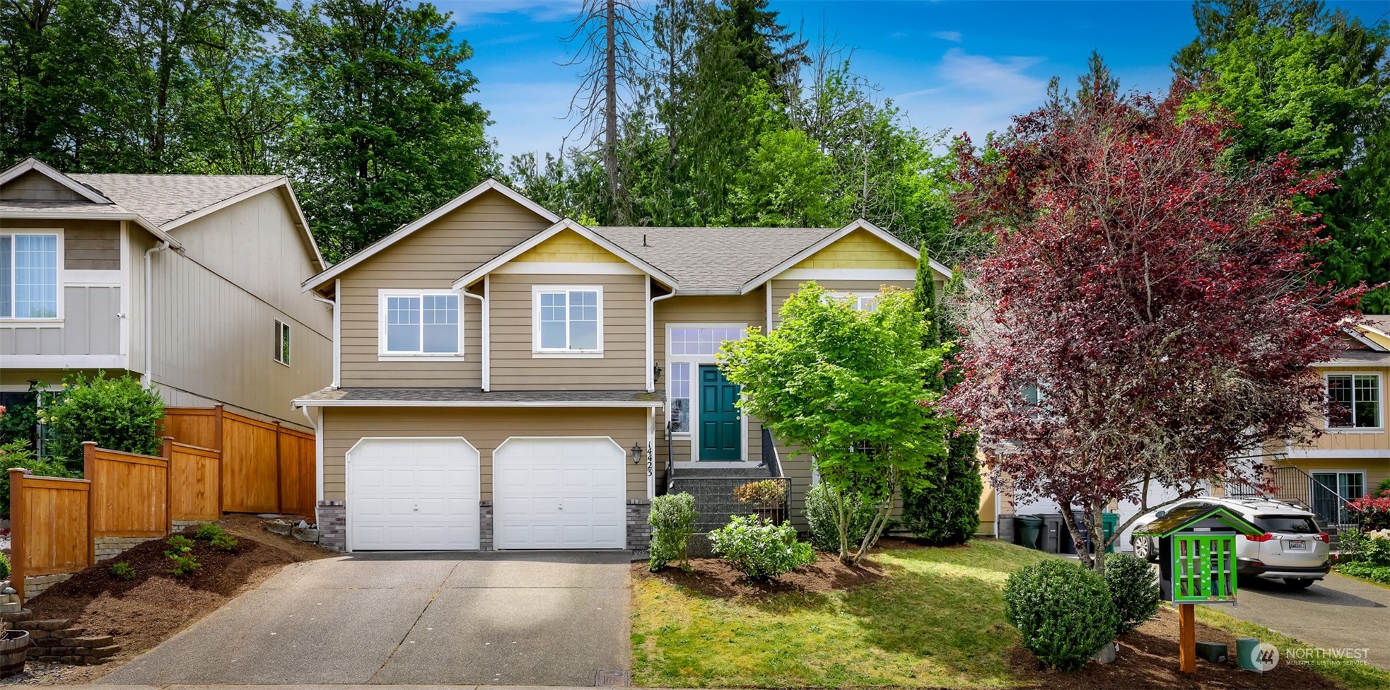 14423 Southeast 188 Way Renton, WA 98058 - Photo 1 of 40 a front view of a house with a garden and plants