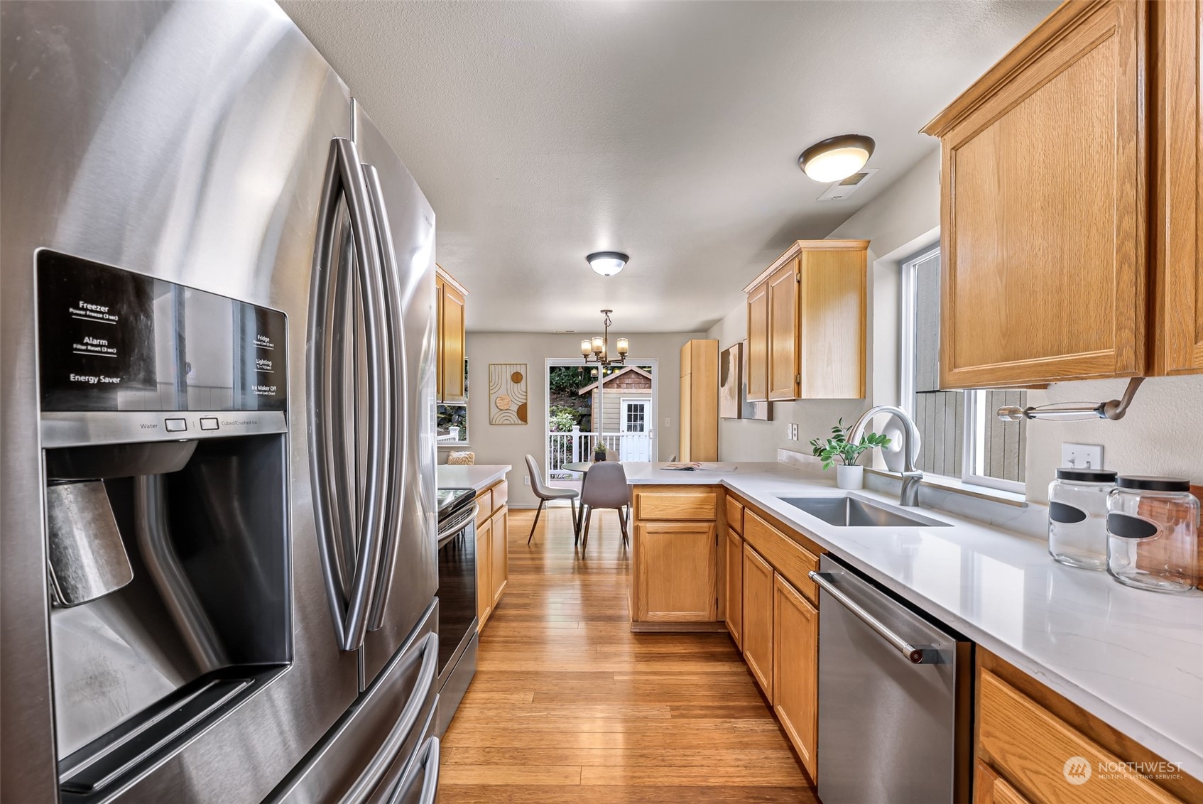 14423 Southeast 188 Way Renton, WA 98058 - Photo 14 of 40 a large kitchen with stainless steel appliances sink a stove and cabinets