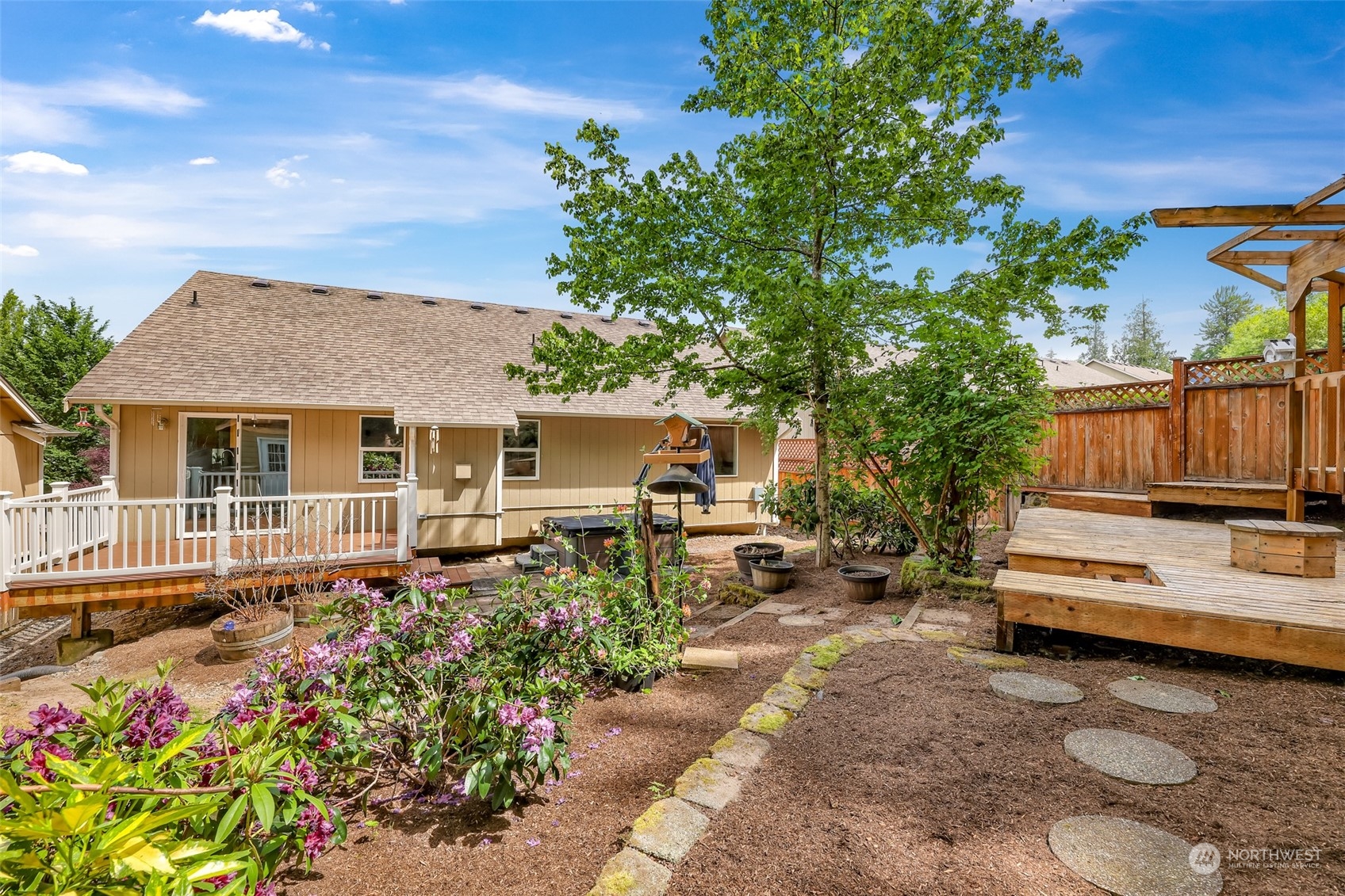 14423 Southeast 188 Way Renton, WA 98058 - Photo 38 of 40 a view of a house with backyard sitting area and garden