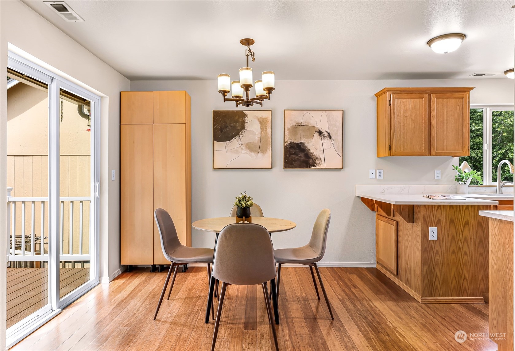 14423 Southeast 188 Way Renton, WA 98058 - Photo 9 of 40 a dining room with wooden floor and a chandelier