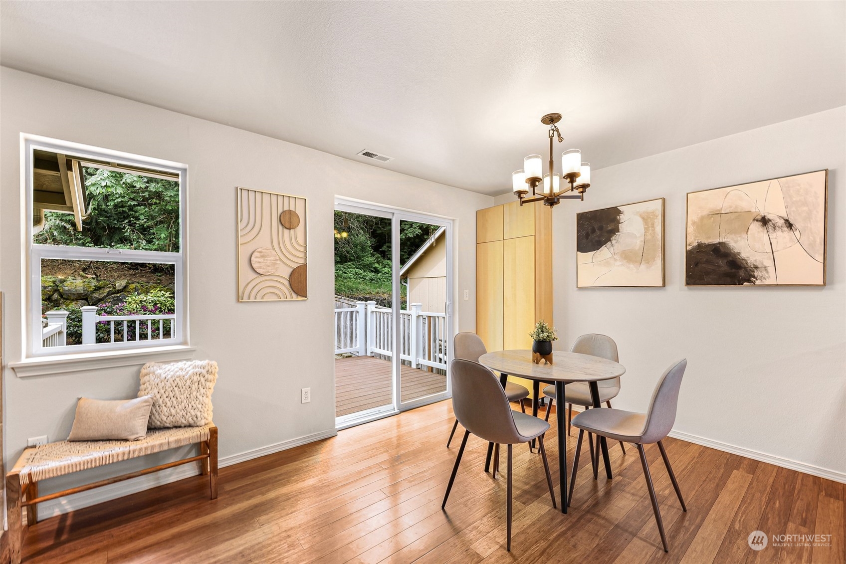 14423 Southeast 188 Way Renton, WA 98058 - Photo 10 of 40 a dining room with furniture a chandelier and wooden floor