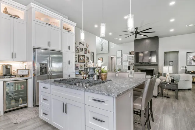 a spacious bedroom with a bed a couch and a large window