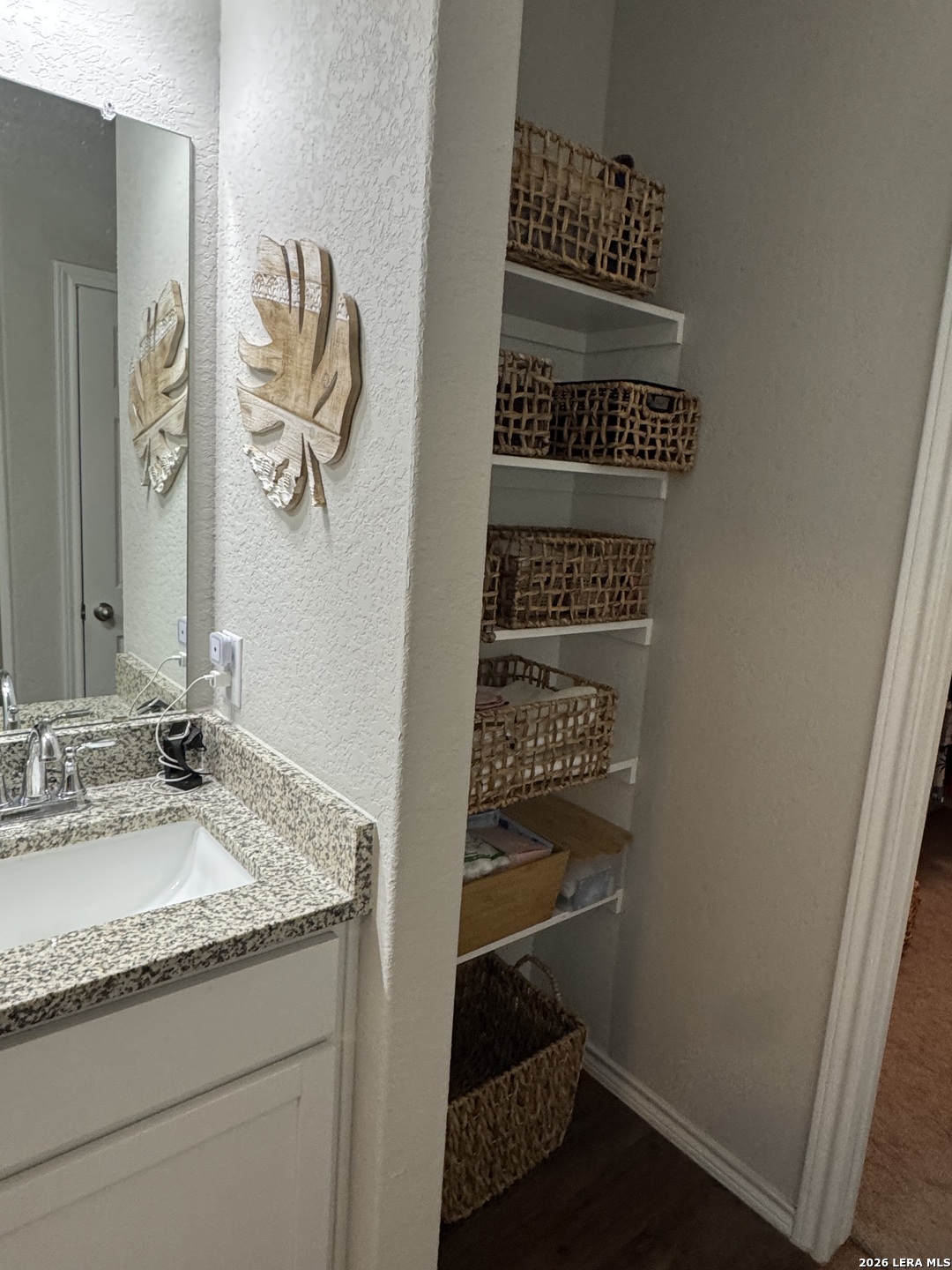 6627 Freedom Ranch San Antonio, TX 78242 - Photo 8 of 10 a bathroom with a granite countertop sink and a mirror