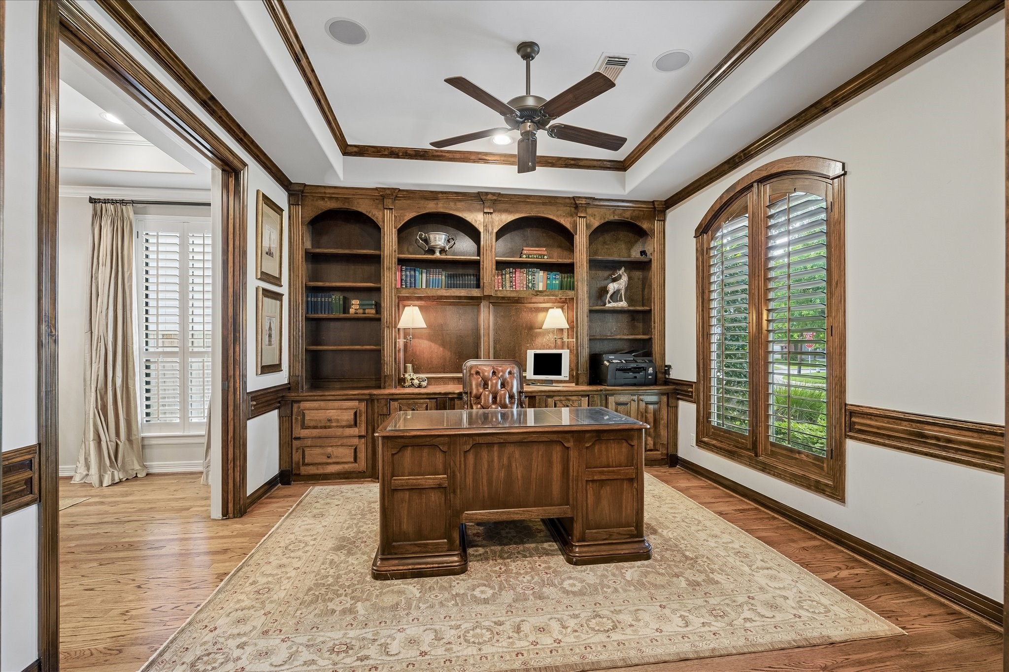 802 Anderson Street Bellaire, TX 77401 - Photo 7 of 36 This home office features wood cased windows, plantation shutters, built-ins, wood trimmed coffered ceilings, solid wood pocket doors and window paneled double doors towards the entry.