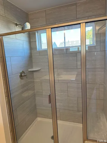 a bathroom with a glass shower door