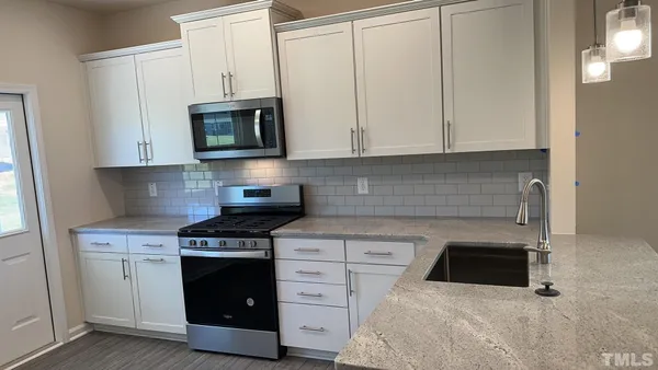 a kitchen with cabinets and appliances