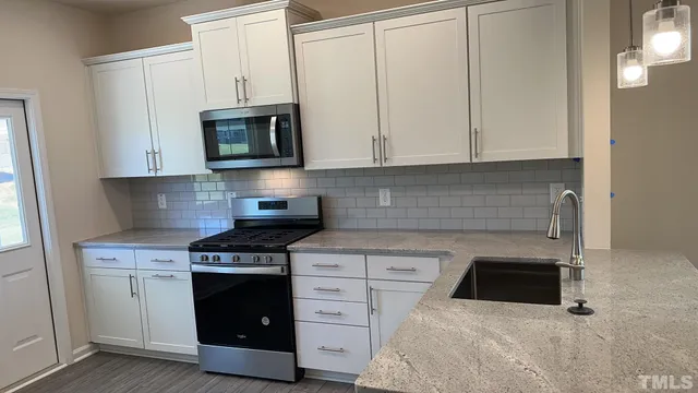 a kitchen with cabinets and appliances